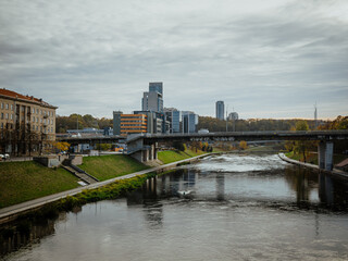 Naklejka premium Neris River with the modern buildings of the new city center (southern Snipiskes)