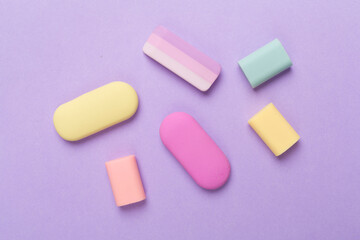 Colorful eraser on color backgroung, top view