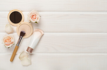 Composition with makeup products for skin tone on wooden background, top view