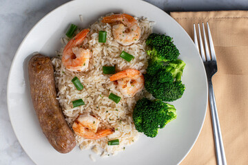 white rice top ith shrimp and green omions
