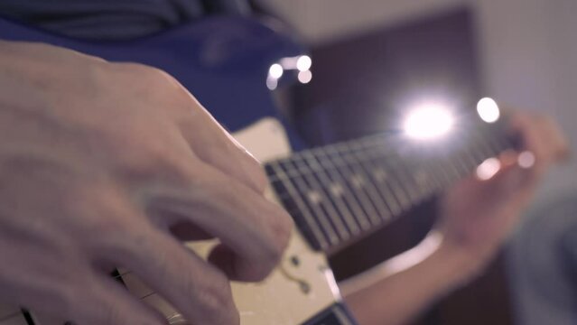 Musician playing guitar in a studio