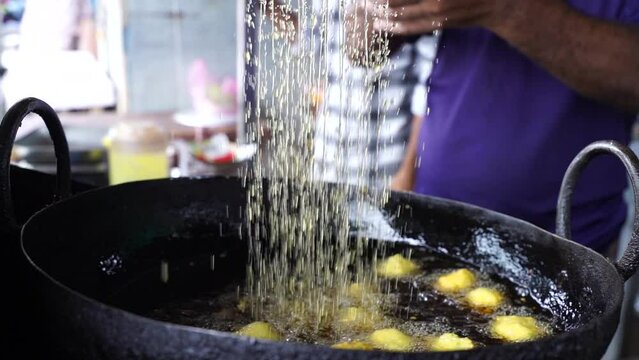 Close-up sense of Making Frying Fritters Indian Street food which is also known
