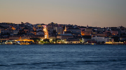 Fototapeta premium View of Lisbon city from Cacilhas at dusk; Concept for travel in Portugal and visit Lisbon
