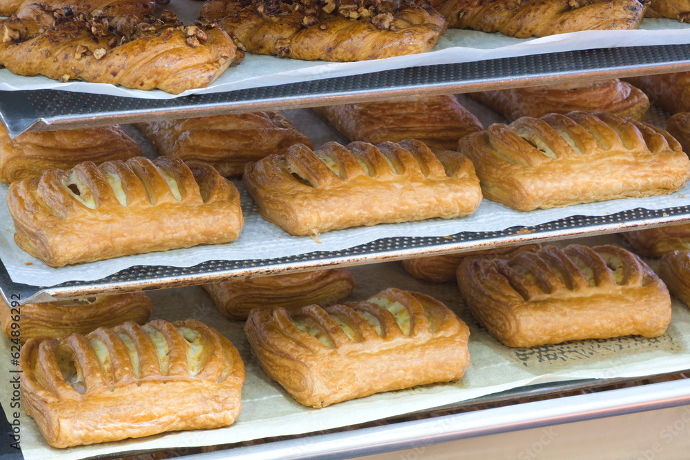 Poster rows of fresh bread loafs lying on the shelf
