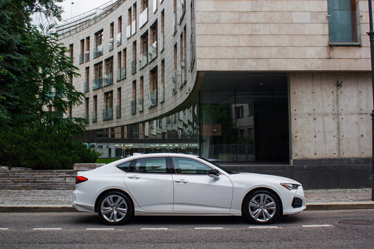 car in the street white Acura 2023 TLX Premium Sport Sedan