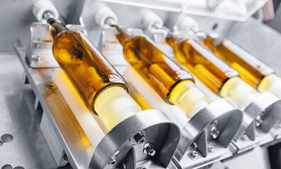 Disinfection and pasteurization process of glass bottles for bottling beer. Brewery factory plant production line