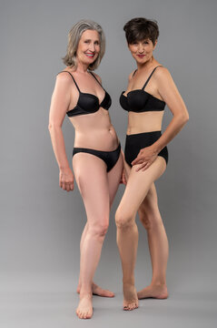 Two Senior Women In Balck Lingerie Standing Close