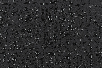 Water drops on dark stone