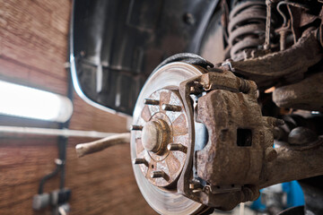 Rusty drum brakes, rear on car. Change the old to new brake disc on car in a garage. Auto mechanic repairing