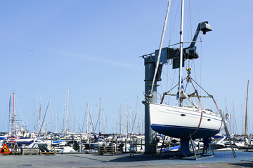 The yacht lifted ashore by a sailboat lift for the maintenance of the underwater part of the hull