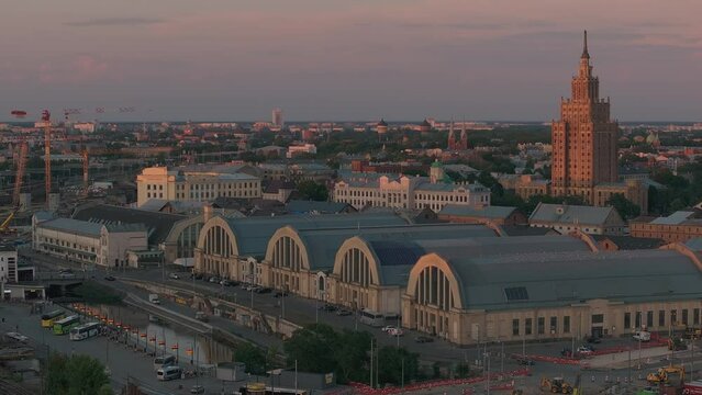 Building Rail Baltica project in the center of Riga. Construction works of roads, railway and bridges in Riga near the market.