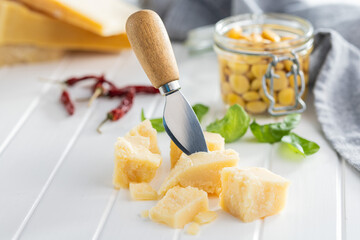 Tasty parmesan cheese on white table. - obrazy, fototapety, plakaty