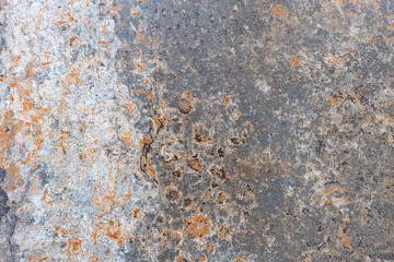 Showing traces of rust over old paint on the surface of a metal sheet.