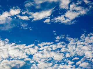 Two groups of altocumulus clouds with a long rift between them on a breezy summer afternoon in southwest Florida, for motifs of apartness