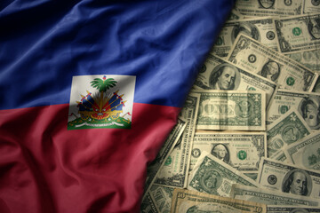 colorful waving national flag of haiti on a american dollar money background. finance concept
