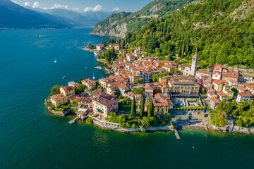 Varenna, Como Lake. Aerial panoramic view of town surrounded by mountains, blue sky and turquoise water and located in Como Lake, Lombardy, Italy - obrazy, fototapety, plakaty