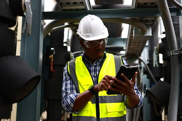 The service engineer is checking the wastewater treatment plant with the pipeline in the...