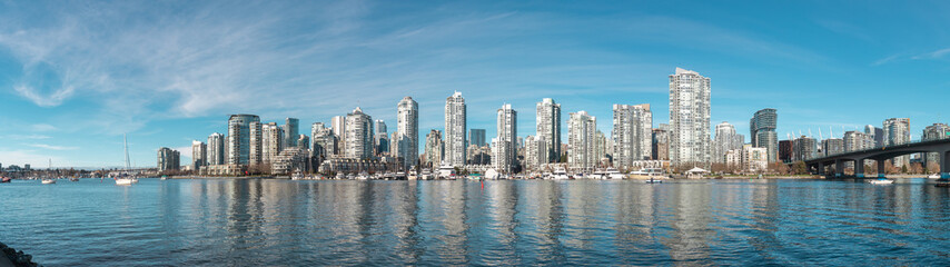 Fototapeta na wymiar Panorama View of Cityscape Downtown Vancouver from Charleson Park. Nice weather, Downtown buildings, False Creek can be seen in an image.