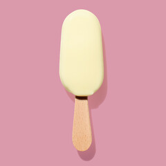 White chocolate ice cream on a stick pink pastel background
