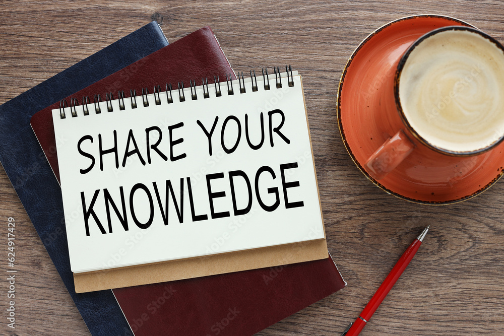 Poster open notebook on a wooden table on two notebooks.orange mug with coffee. words share your knowledge