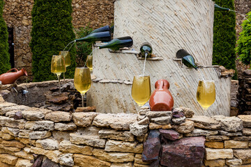 Fountain with white wine pouring from bottles