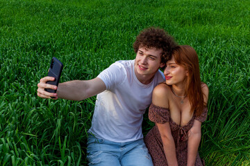 a guy with a girl take a selfie on the phone
