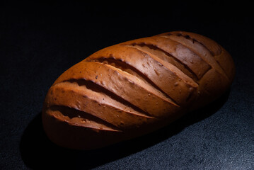 Fresh bread on a black background close-up