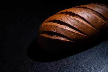 Fresh bread on a black background close-up