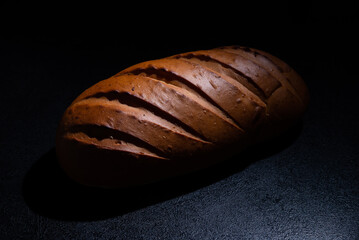 Fresh bread on a black background close-up