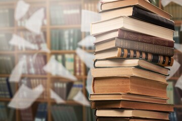 A stack of old reading books and flying pages