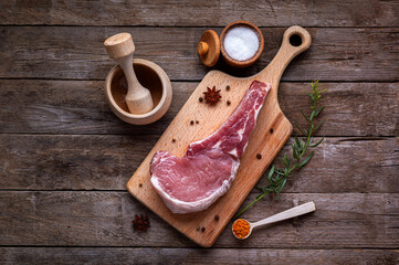 Indulge in the rustic charm of a raw piece of pork loin on a wooden board.