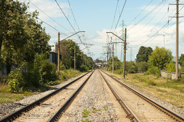 Fototapeta premium railway, in the photo rails against the background of a blue sky and clouds