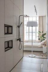fashionable stylish shower area in a minimalistic modern luxury design of an expensive house on a sunny day in white with a round mirror and a floor sink