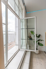 minimalistic modern luxury design of an expensive house with marble trim on a sunny day. white walls with plaster, parquet, decorative lighting and no one inside