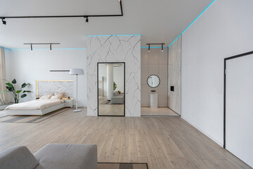 minimalistic modern luxury design of an expensive house with marble trim on a sunny day. white walls with plaster, parquet, decorative lighting and no one inside