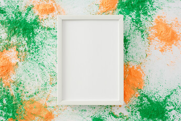 Happy Independence Day, India. Top view composition of colorful powder splashes on white background with blank frame for advert or message