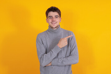 isolated young man or teenager pointing smiling