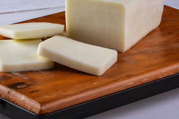 sliced buffalo mozzarella bar on wooden board