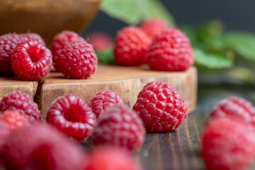 Ripe raspberries on a wooden board