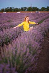 lavender field, a young woman in a yellow blouse and sunglasses walks in the field and smiles happily, summer july, lavender cultivation