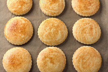 Freshly baked milk shortcakes on parchment, top view. DIY, step by step, step 10