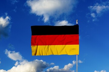 The German flag wave in the wind on sky background
