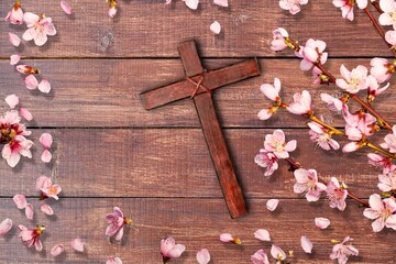 Wooden Christian cross with fresh flowers