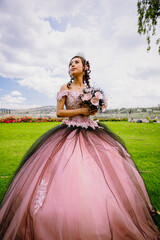Portrait of a Mexican teen quinceanera, Hispanic teen girl wearing a dress