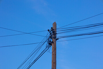 power pole with tangled telephone connection cables
