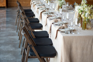 beautiful table setting with flowers and cutlery on wooden table at wedding or dinner. stylish tablewear decorations
