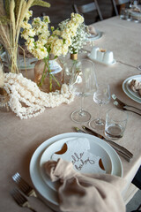 Beautiful wedding table decorations. Tablewear and bouquet of flowers.