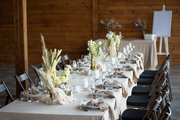 Beautiful wedding table decorations. Tablewear and bouquet of flowers.