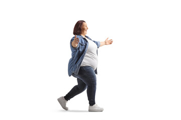 Happy young overweight woman in casual clothing walking with arms wide open