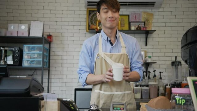 Coffee shop concept of 4k Resolution. The barista is delivering coffee mugs to customers in the shop.